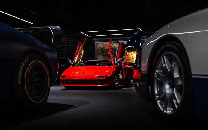 Red sports car with open doors at Coligny Car Museum, Lyon, France.