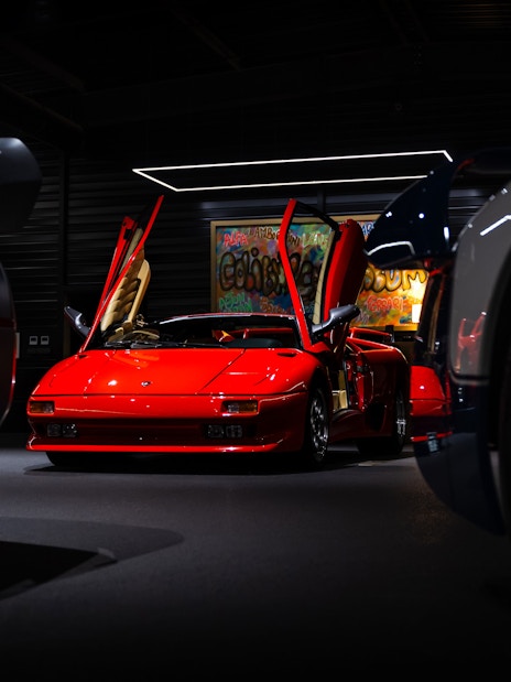 Red sports car with open doors at Coligny Car Museum, Lyon, France.