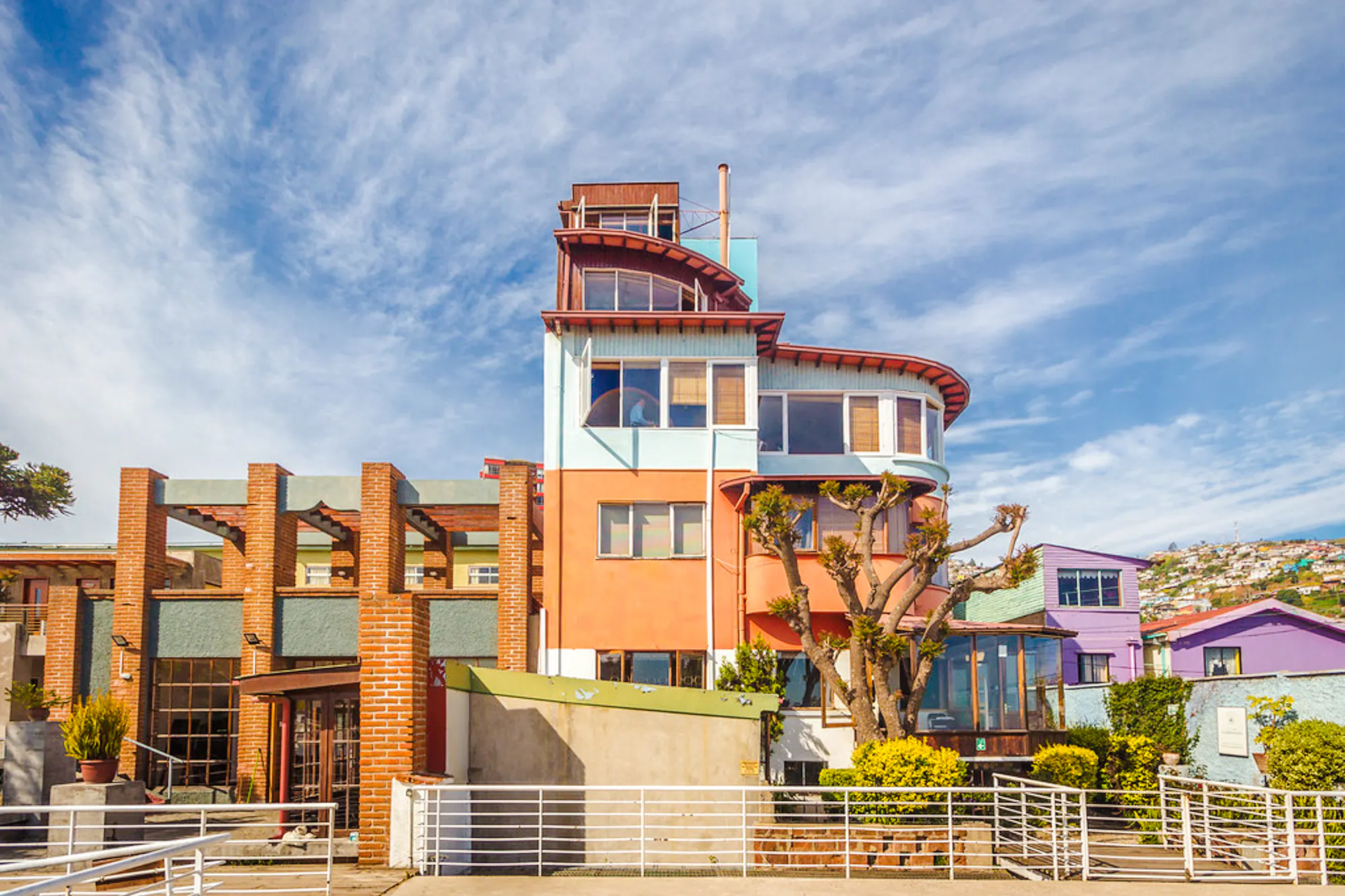 Colorful house in Valparaíso, Chile, with vibrant architecture and surrounding hillside homes.