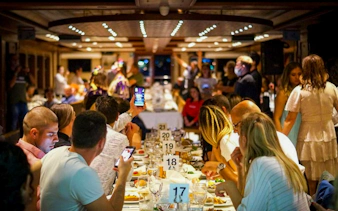 Guests dining on a Bosphorus dinner cruise with Turkish night show in Istanbul.