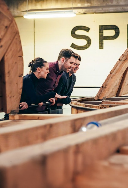 Visitors observing whiskey barrels at Teeling Whiskey Distillery, Dublin.