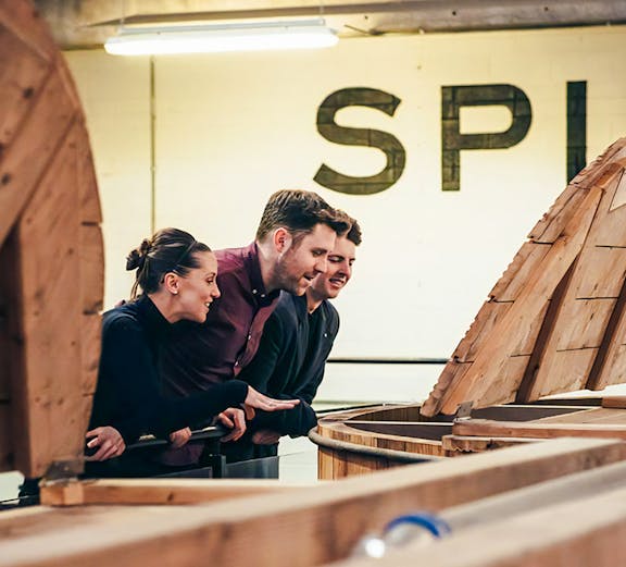 Visitors observing whiskey barrels at Teeling Whiskey Distillery, Dublin.