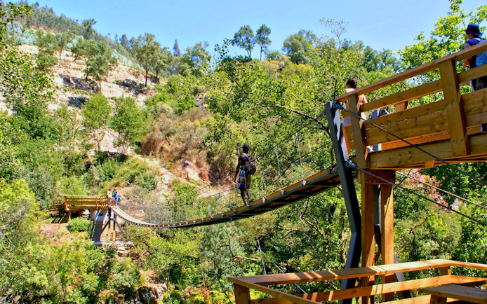 Visitors crossing a suspension bridge on the Paiva Walkways in Arouca, Portugal.