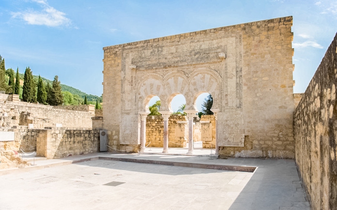Medina Azahara arched entrance with stone carvings, Córdoba, Spain.