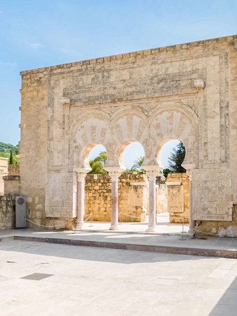 Medina Azahara arched entrance with stone carvings, Córdoba, Spain.