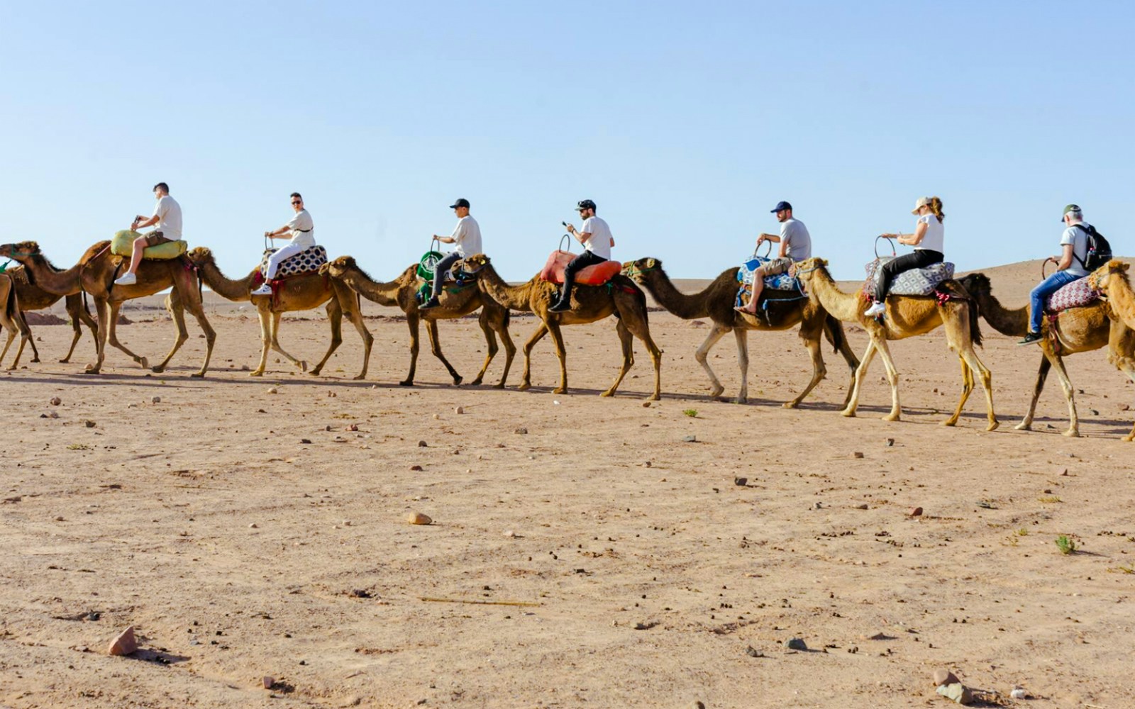 People riding camels in Agafay Desert, Marrakesh.