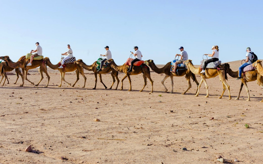 People riding camels in Agafay Desert, Marrakesh.