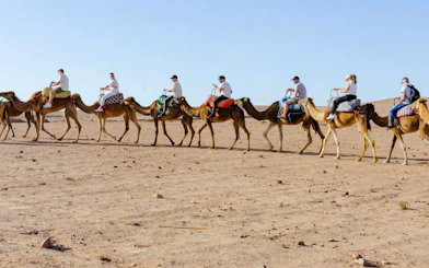People riding camels in Agafay Desert, Marrakesh.