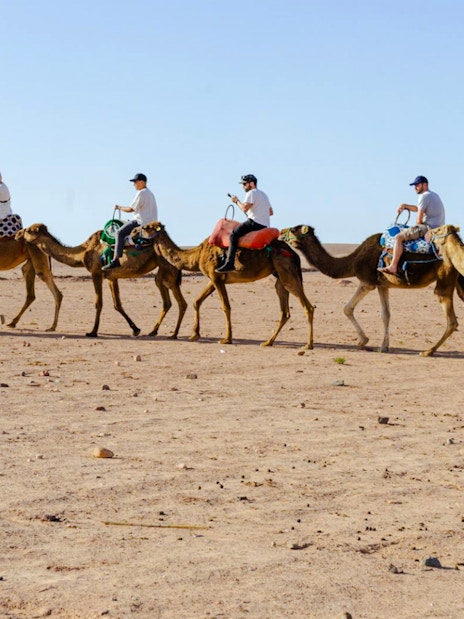 People riding camels in Agafay Desert, Marrakesh.