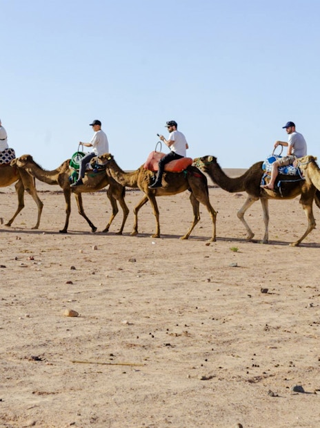 People riding camels in Agafay Desert, Marrakesh.