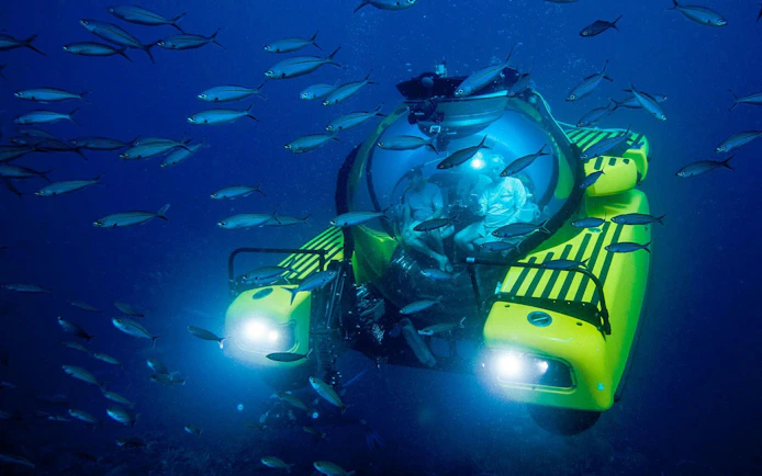Tourists inside submersible at "Into the Ocean: Journey Beneath" exhibition, Singapore ArtScience Museum.