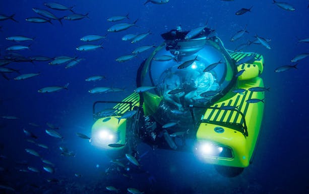 Tourists inside submersible at "Into the Ocean: Journey Beneath" exhibition, Singapore ArtScience Museum.