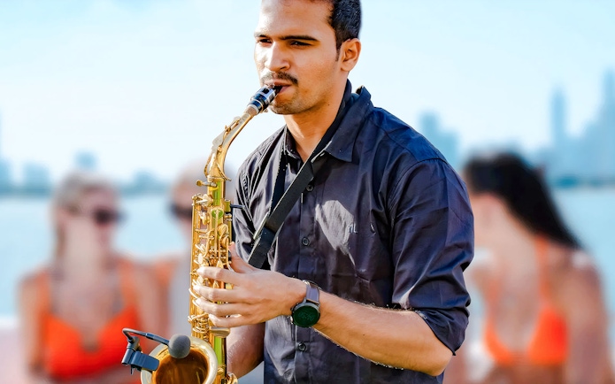Musician playing saxophone on a luxury yacht in Dubai.