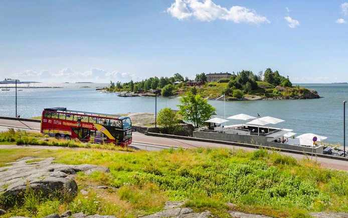 Helsinki sightseeing bus near waterfront during Hop-on Hop-off tour.