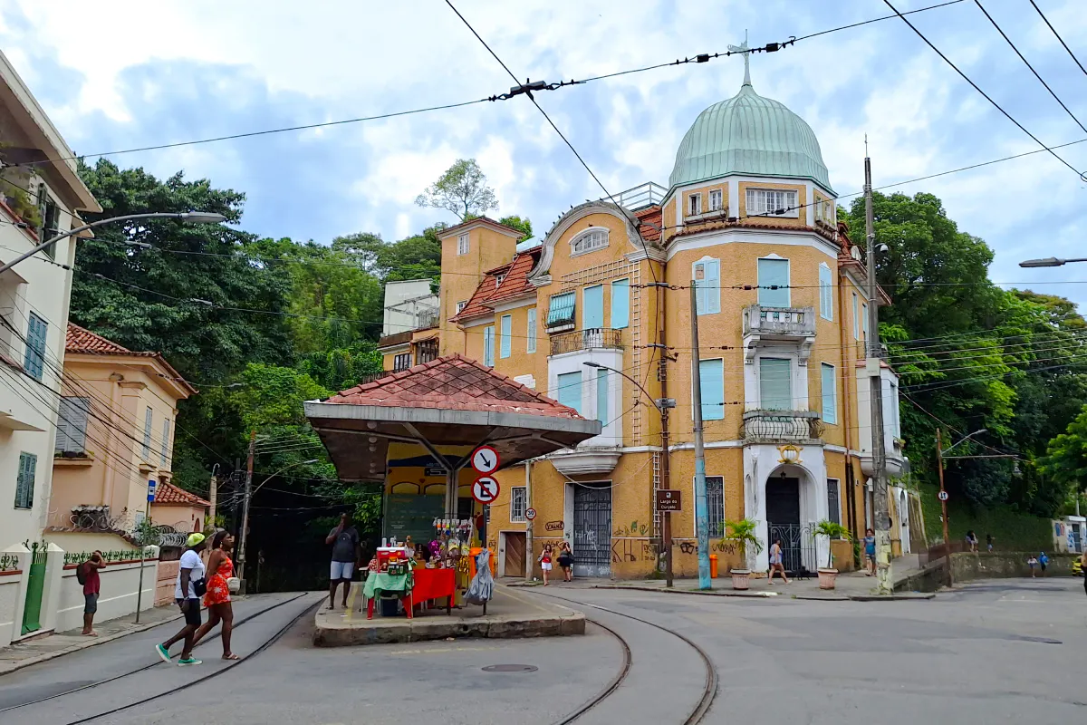 Yellow tram stop and historic building in Santa Teresa, Rio de Janeiro.