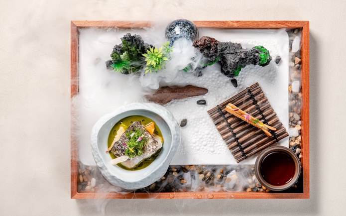 Curated dish on themed tray at Taste of China, Shanghai, featuring artistic presentation.