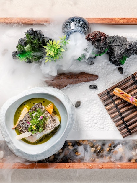 Curated dish on themed tray at Taste of China, Shanghai, featuring artistic presentation.