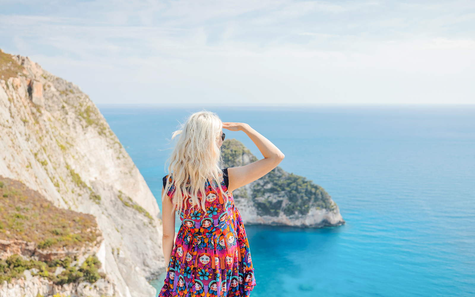 Guests enjoying the view from Navagio Viewpoint, Zakynthos, overlooking cliffs and sea.