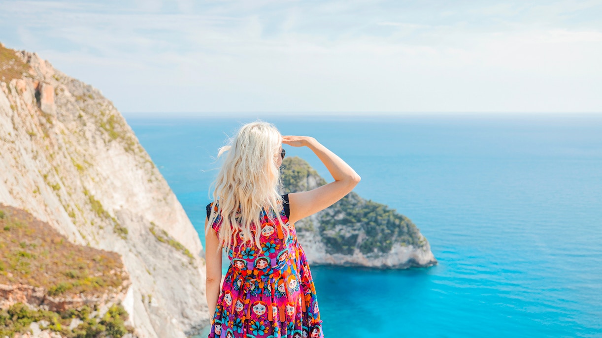 Guests enjoying the view from Navagio Viewpoint, Zakynthos, overlooking cliffs and sea.