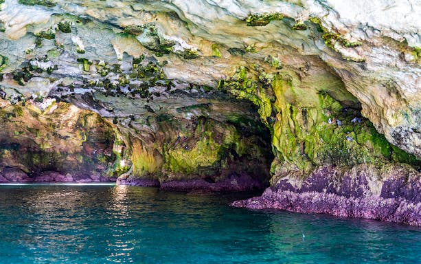 Polignano a Mare cave interior with turquoise water during boat tour.