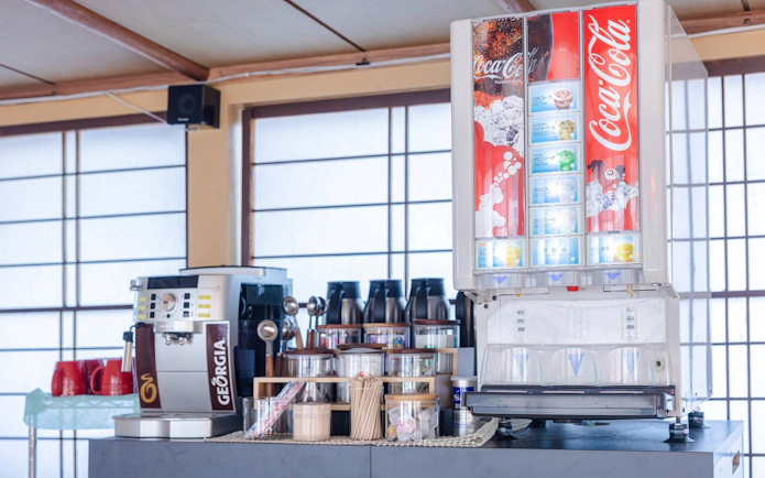 Tea ceremony room in Tokyo with beverage machines and traditional decor.