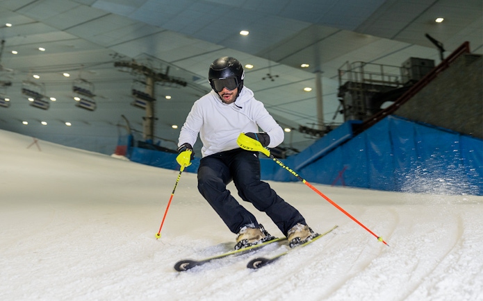 Skier navigating indoor slope at Ski Dubai during full day session.