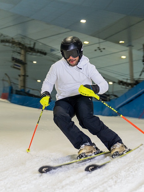 Skier navigating indoor slope at Ski Dubai during full day session.