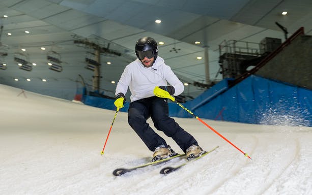 Skier navigating indoor slope at Ski Dubai during full day session.