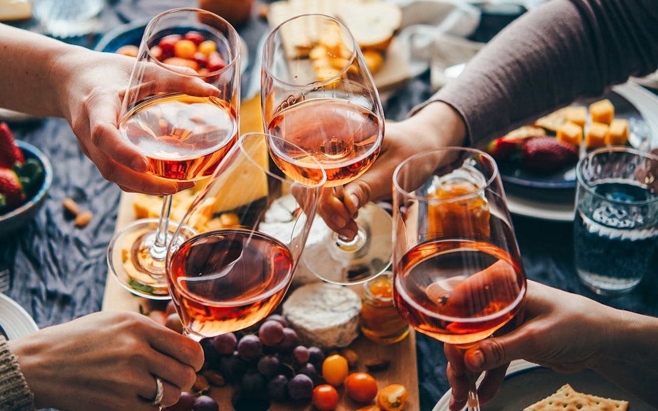 People toasting with wine at Cheese Museum Paris, France.