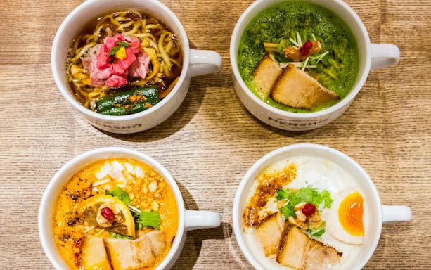 Four bowls of diverse ramen from Tokyo Ramen Tasting Tour on a wooden table.