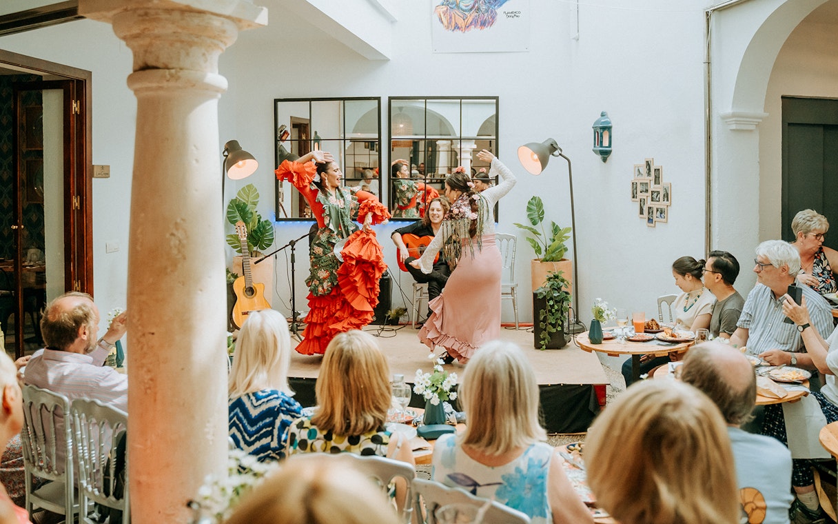 Flamenco dancers performing at Cepa Doble Tavern with audience seated.