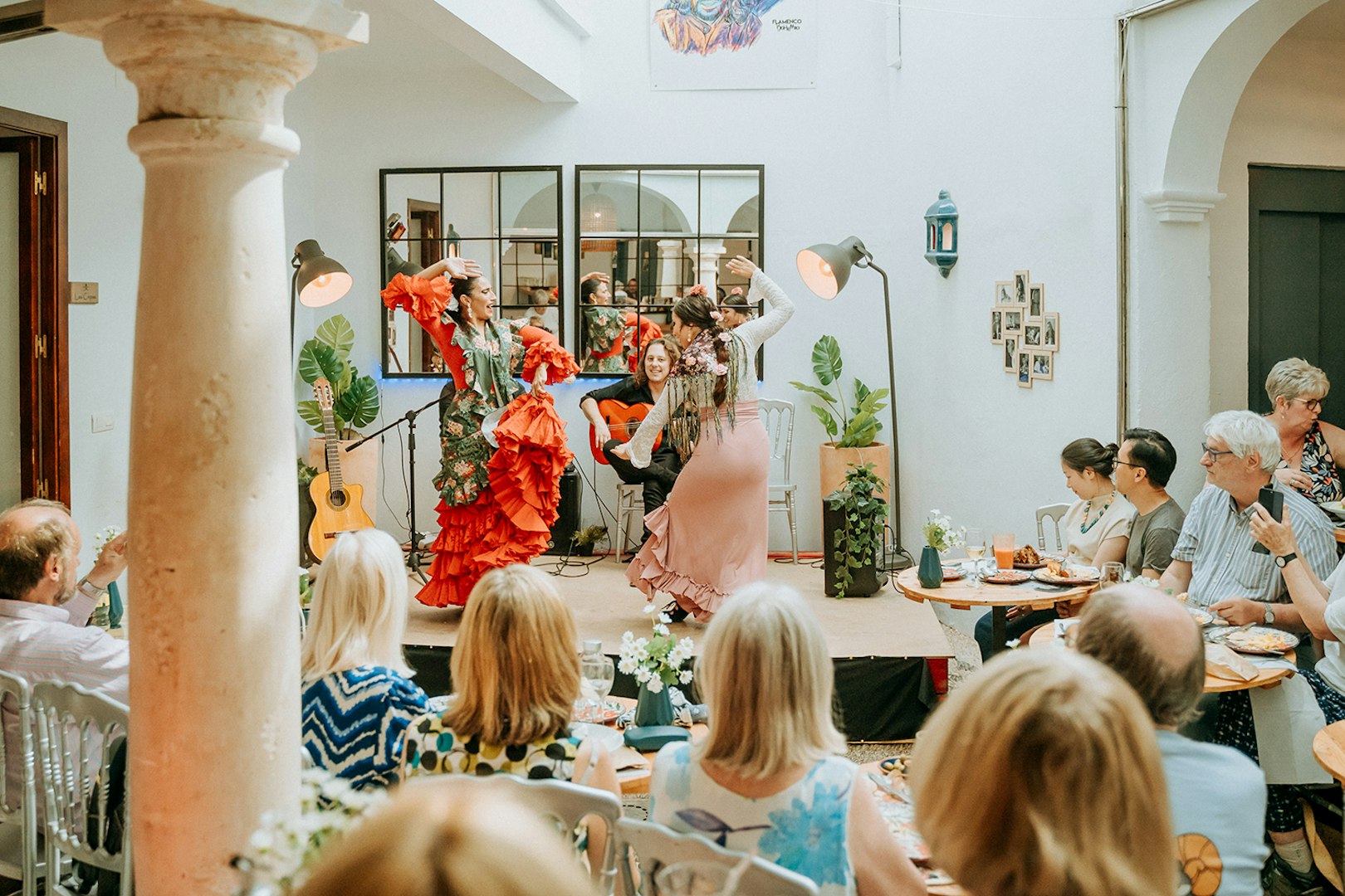 Flamenco dancers performing at Cepa Doble Tavern with audience seated.