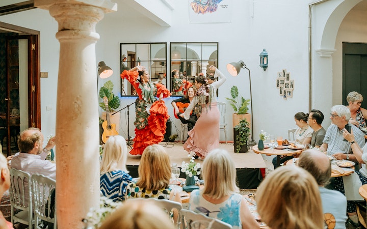 Flamenco dancers performing at Cepa Doble Tavern with audience seated.