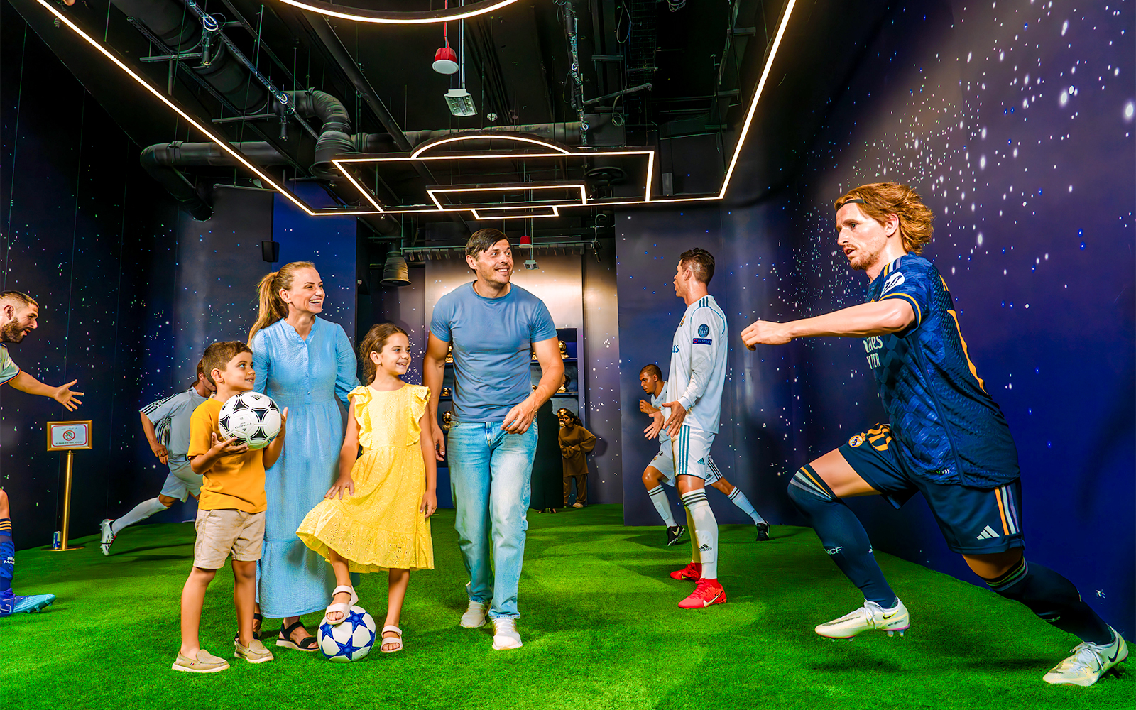 Family admiring star statue at Meet the Star, Real Madrid World, Dubai.