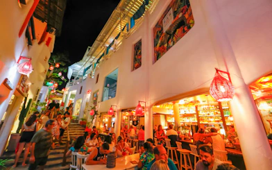 Outdoor dining and nightlife scene in Pipa Village, Sao Paulo, with people enjoying a vibrant evening.