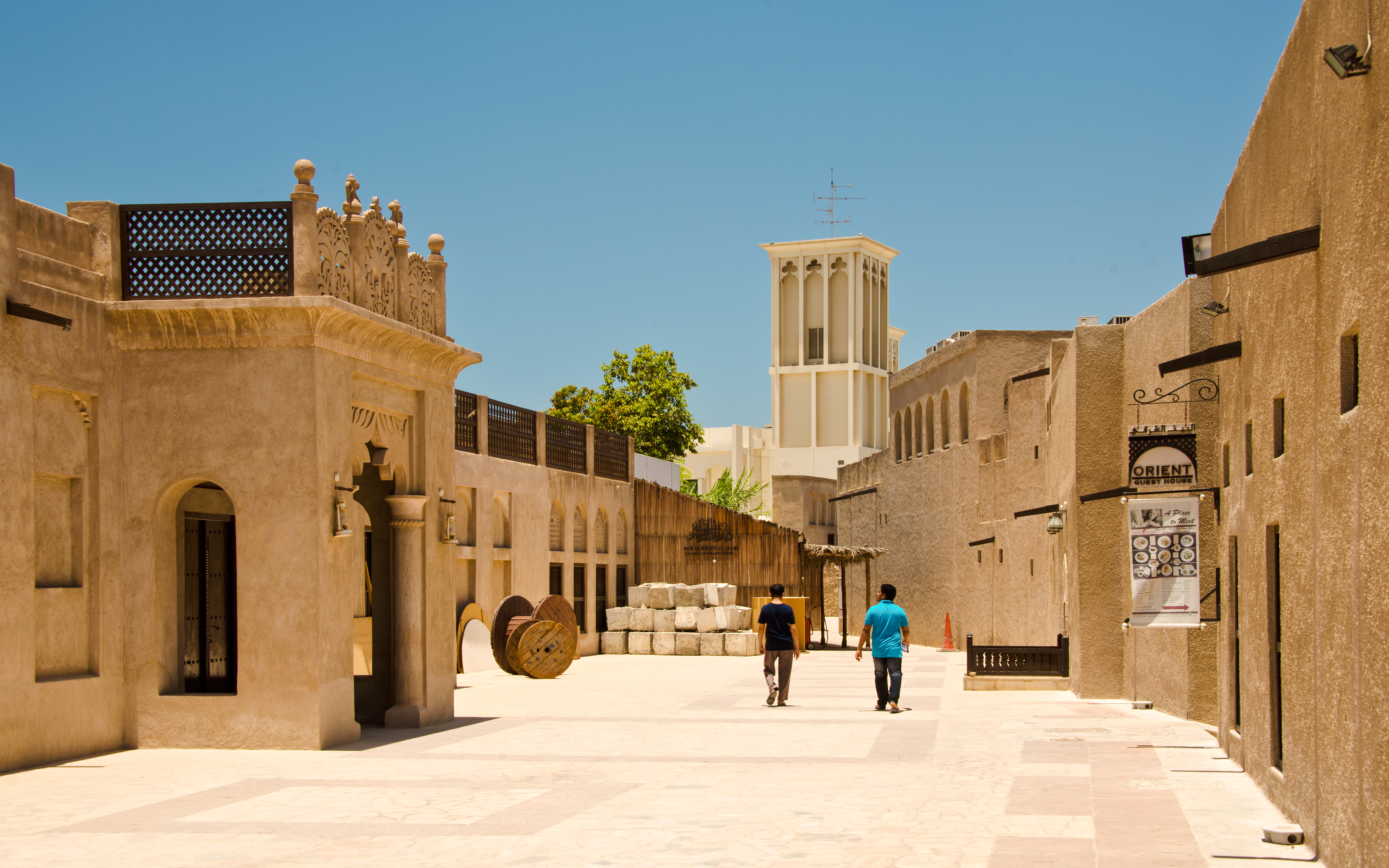 People walking through the historic Bastakiya district in Dubai.