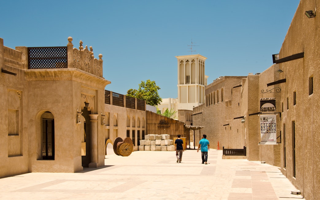 People walking through the historic Bastakiya district in Dubai.
