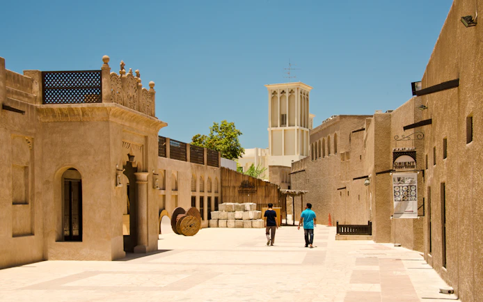 People walking through the historic Bastakiya district in Dubai.