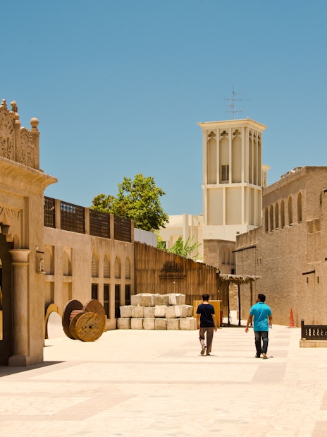 People walking through the historic Bastakiya district in Dubai.