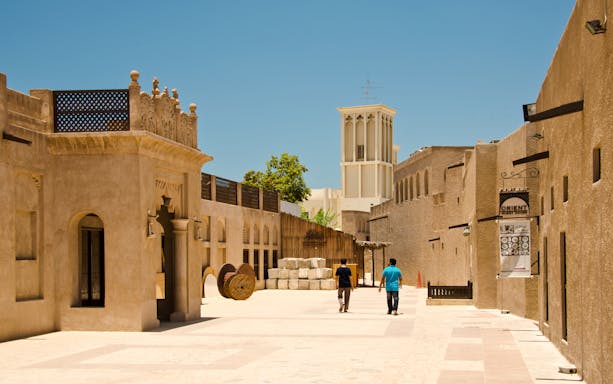 People walking through the historic Bastakiya district in Dubai.