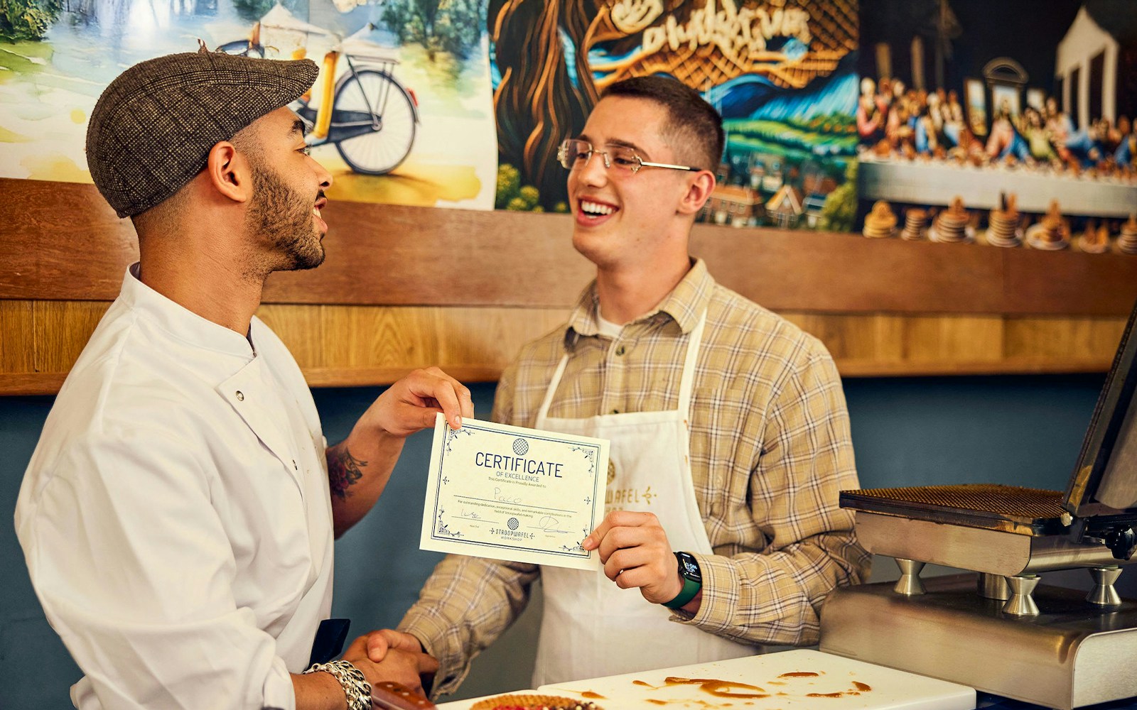 Man receiving certificate at Dutch syrup waffle workshop.