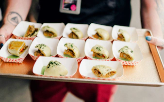 Assorted dumplings on a tray during a chef-guided food tour at Pike Place Market.