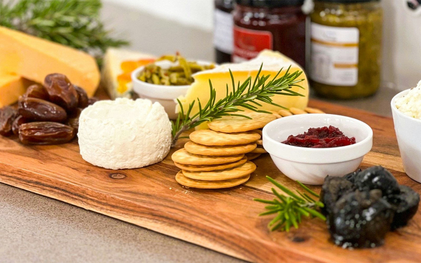Cheese platter with crackers, dates, and condiments on Yarra Valley Full Day Grazing Tour.