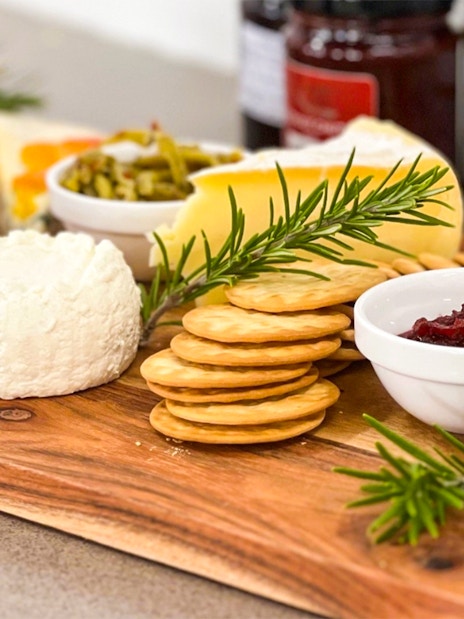 Cheese platter with crackers, dates, and condiments on Yarra Valley Full Day Grazing Tour.