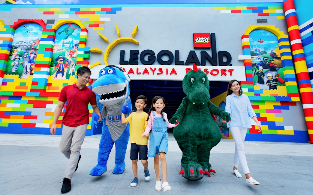 Visitors with mascots at LEGOLAND® Malaysia entrance.