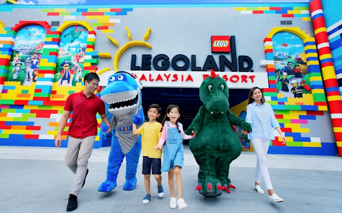 Visitors with mascots at LEGOLAND® Malaysia entrance.