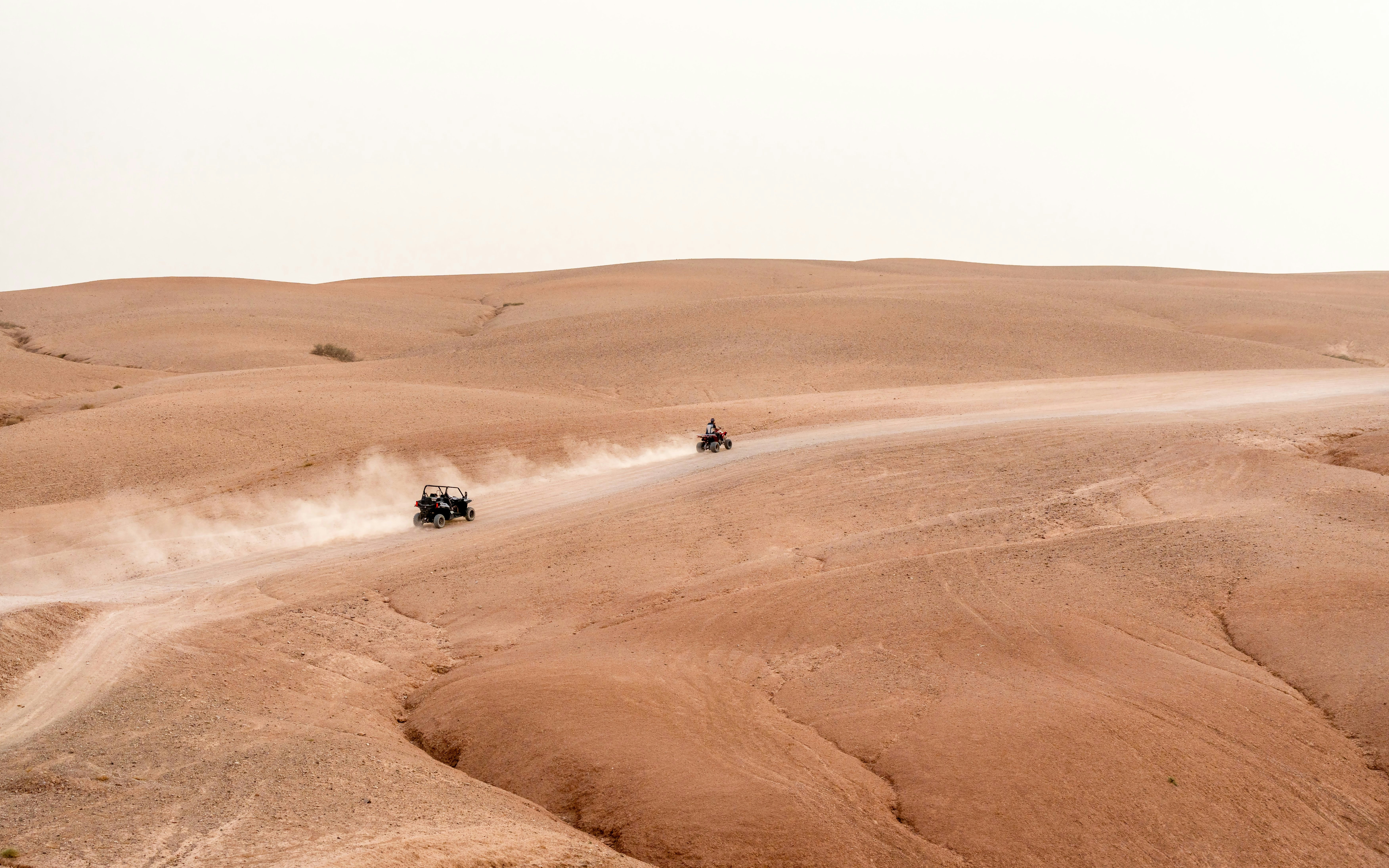 Quad biking on sandy trails in the Agafay Desert, Morocco.