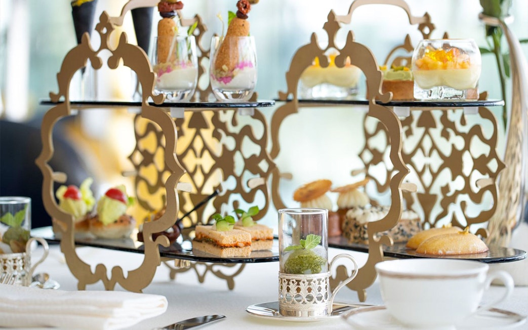 Afternoon tea setup with desserts and beverages at Burj Al Arab tour.