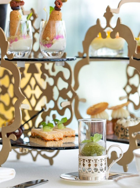 Afternoon tea setup with desserts and beverages at Burj Al Arab tour.
