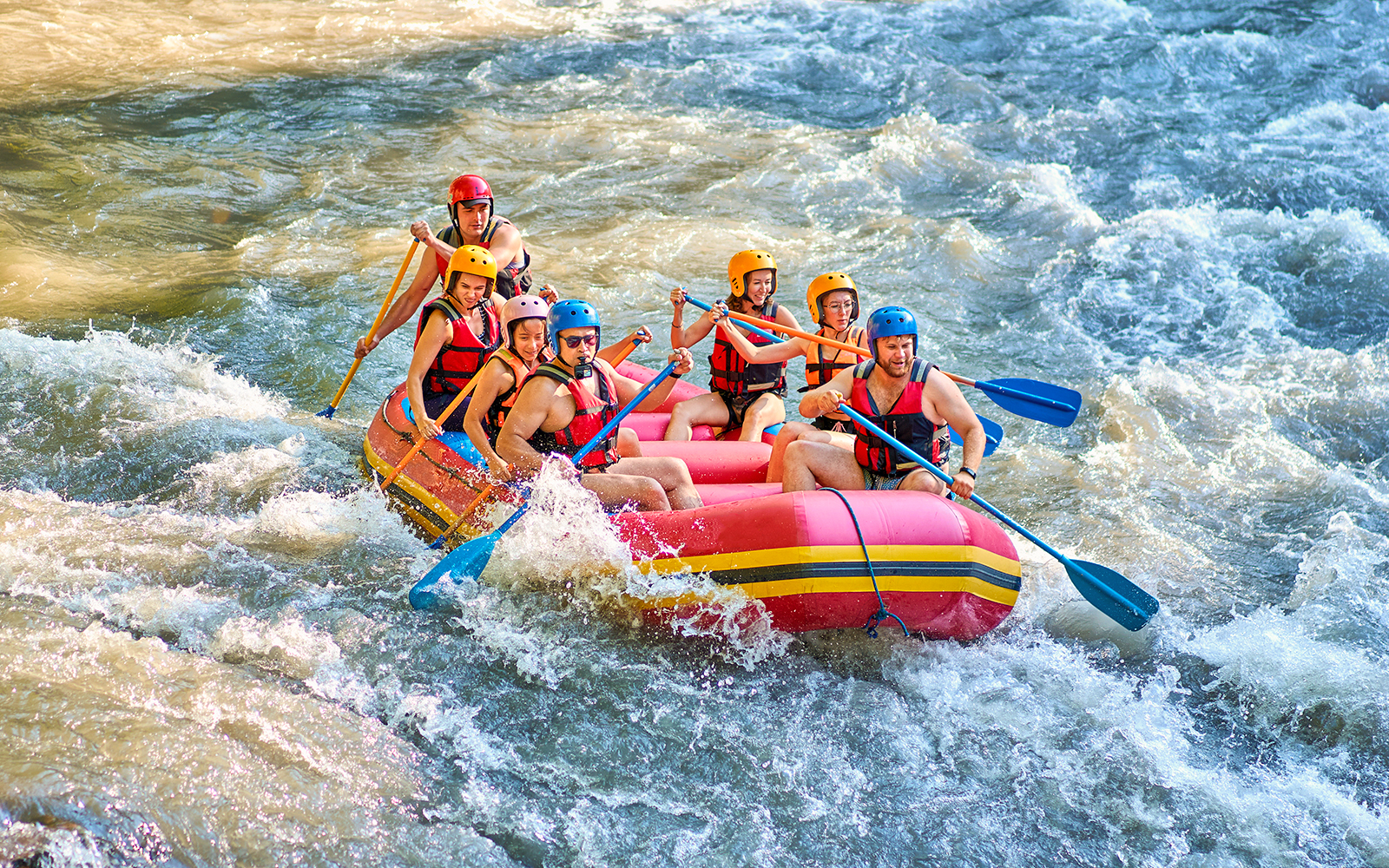 White water rafting group navigating rapids in Bali.